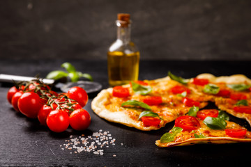 Pizza Margarita with Mozzarella and Basil on the Black Background Bake Snack with Tomatoes