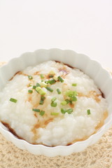 Chinese food, soy sauce and spring onion on congee