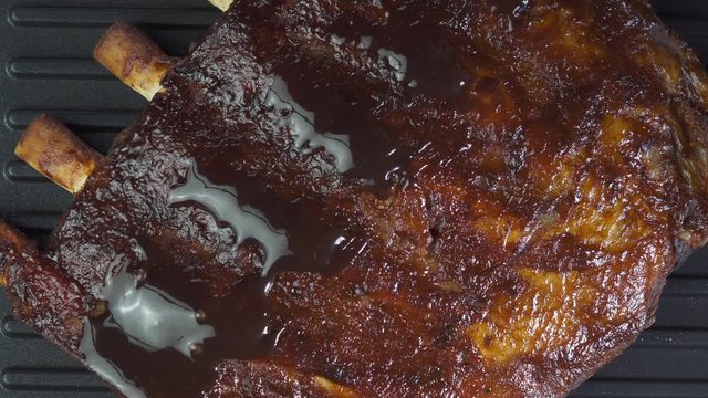 Closeup of spare rib preparing with glaze on barbecue grill