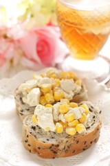 corn and cream cheese on bread with iced tea