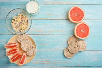Fototapeta premium Grapefruit, muesli and bread. View from above, with an empty place for the inscription. The concept of a diet