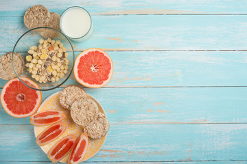 Grapefruit, muesli and bread. View from above, with an empty place for the inscription. The concept of a diet