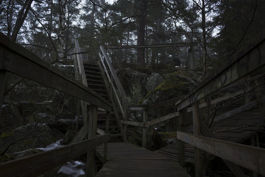Bridge over a lake and stairway up a mountain, to a forest. Nackareservatet - nature reserve in Sweden