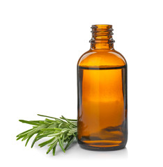 Bottle with rosemary essential oil and fresh herb on white background