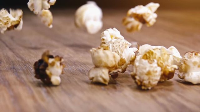 Heap of popcorn gets overturned by other popcorns in slow motion.