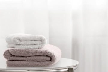 Naklejka na ściany i meble Stack of clean towels on table indoors