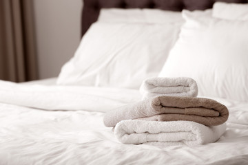 Fototapeta na wymiar Stack of clean towels on bed