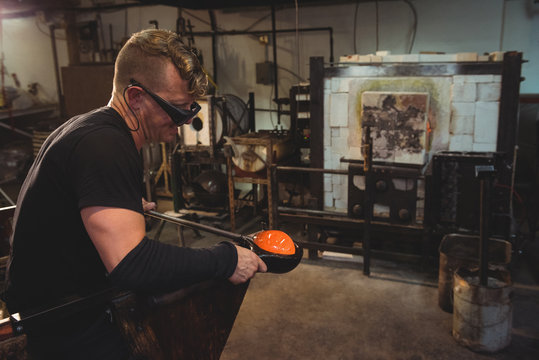 Glass blower working in workshop