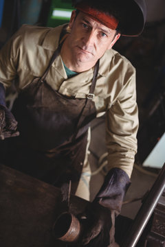 Portrait of welder standing in workshop