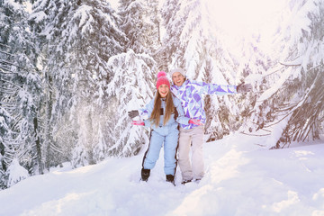 Happy couple having fun in snowy countryside. Winter vacation