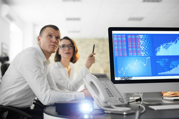 Office employees watching presentation during meeting. Forex concept
