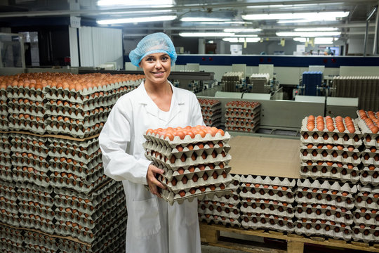 Female staff holding a carton of eggs