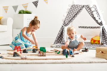 happy children playing in toys at home in   playroom