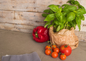 Fresh basil and other ingredients for Italian cuisine. Cherry tomatoes, basil and red pepper