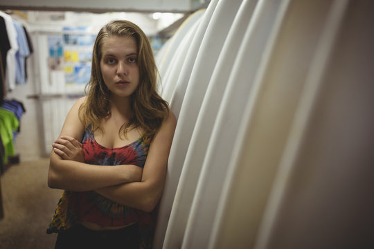 Woman standing with arms crossed in beach cabin