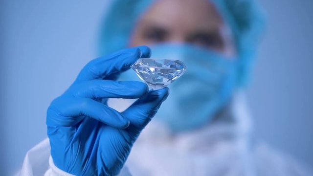 Scientist examining crystal, expert evaluation of precious stone, diamond mining