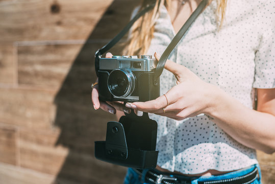 Cropped woman with vintage old camera