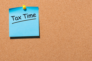 Tax time - Notification of the need to file tax returns pinned at cork board, tax form at accauntant workplace. With empty space for text, mockup or template
