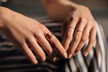 Fotobehang Crop woman hands with rings on the street © DavidPrado