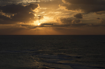 Sunset behind dark clouds