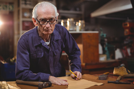 Portrait of senior man working in workshop