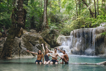 Fototapeta na wymiar Group of diverse friends enjoying the waterfall