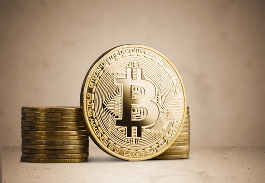 Golden Bitcoin on coin stack