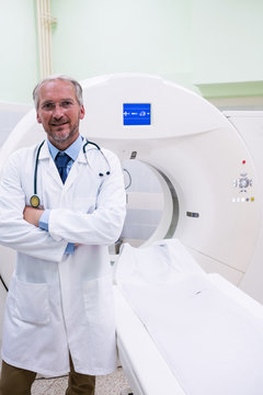 Portrait of doctor standing near mri scanner