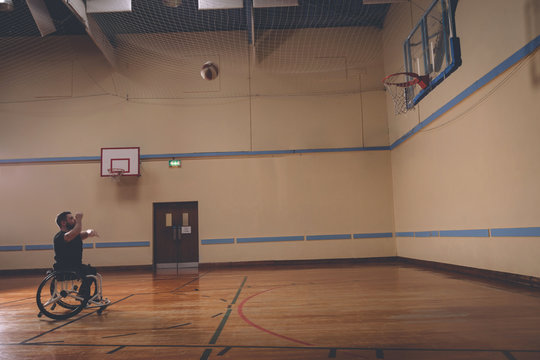 Disabled man practicing basketball in the court