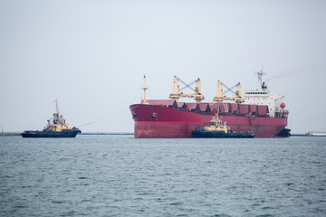 Vessel dry cargo on loading, unloading in port. Bulker in port.