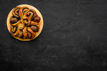 Obraz na płótnie Canvas Bakery. Big pastry with poppy on black background top view copy space