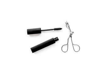 Basic products for eyelashes makeup. Mascara and eyelash curler on white background top view copy space