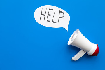 Call for help concept. Megaphone near cloud with word help on blue background top view space for text