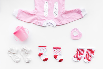 Clothes and accessories for newborn and small children on white background top view