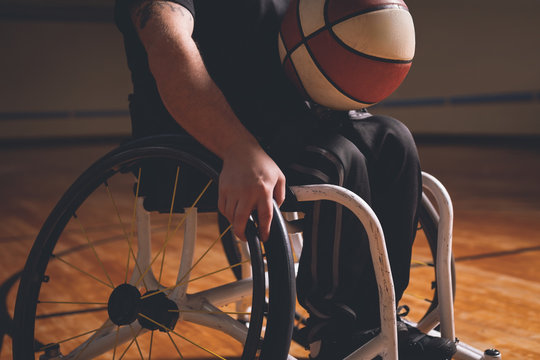 Disabled man practicing basketball in the court