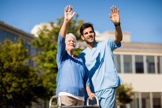 Nurse pushing the senior womans Zimmer frame