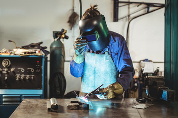 Female welder working in workshop