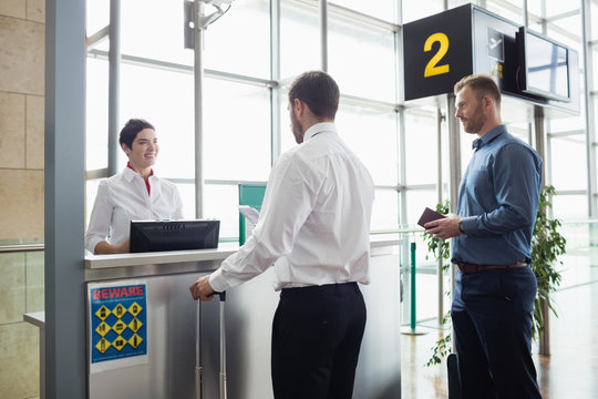 Man giving his passport to airline check-in attendant