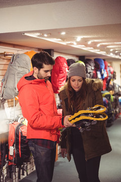 Couple looking at snowshoes in a shop