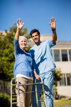 Nurse pushing the senior womans Zimmer frame