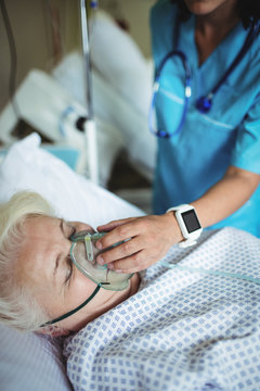 Nurse Putting Oxygen Mask On Patient