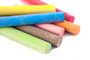 Colored chalks on white background with soft shadows