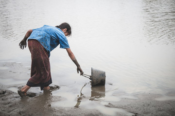 Woman hand are scooping water on cracked ground, Crisis of water shortage.