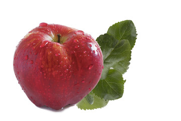 one large red ripe whole apple with green leaves