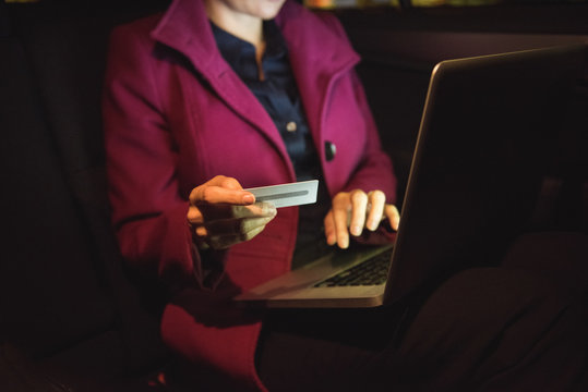 Businesswoman doing online shopping on laptop with credit card