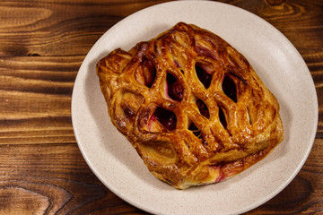 Delicious cherry strudel on wooden table
