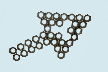 Pointer from nuts on cyan background close up. Image of arrow on blue backdrop.