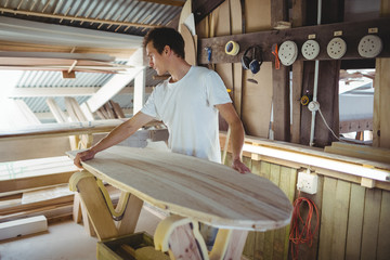 Man making surfboard
