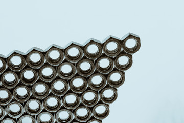 Triangle from nuts on cyan background close up.