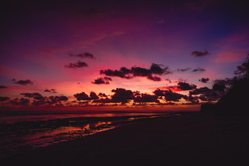 Fototapeta na wymiar Bright sunset or sunrise at ocean with clouds in Bali